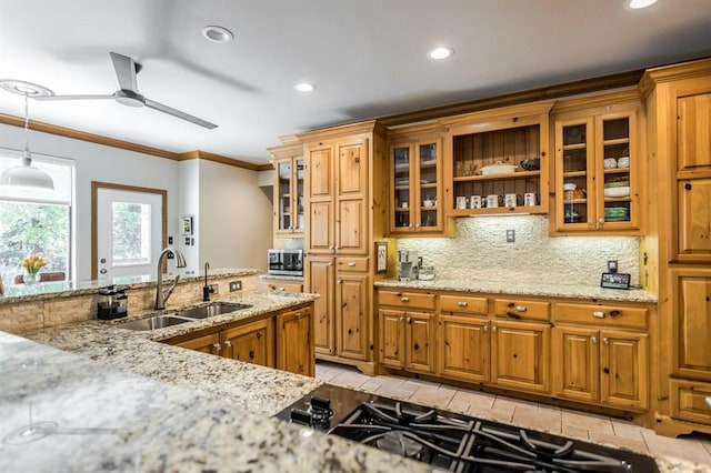kitchen featuring brown cabinets, ornamental molding, and a sink