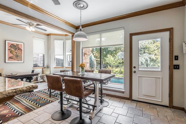 dining space with baseboards, ceiling fan, ornamental molding, and stone finish flooring