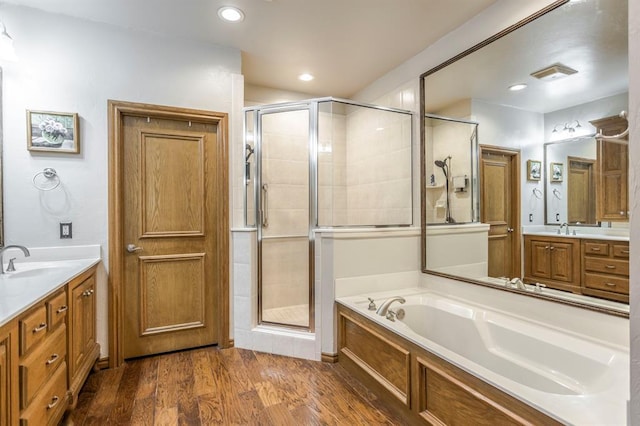 full bathroom featuring recessed lighting, a shower stall, a garden tub, and vanity