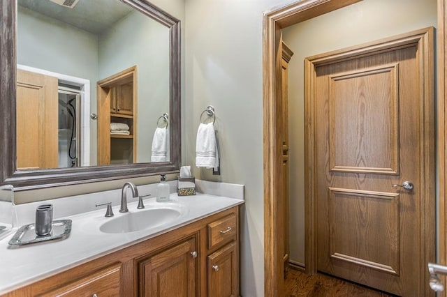 bathroom with vanity and wood finished floors