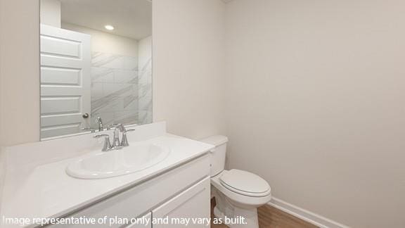 bathroom featuring recessed lighting, vanity, baseboards, and toilet