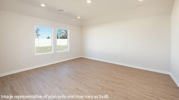 spare room featuring recessed lighting, baseboards, and wood finished floors
