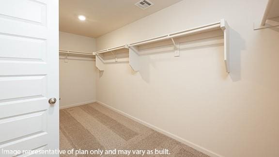 spacious closet with visible vents and carpet flooring