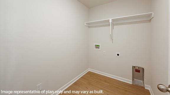 laundry room with laundry area, hookup for a washing machine, baseboards, and wood finished floors