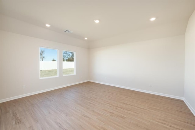empty room with visible vents, recessed lighting, light wood finished floors, and baseboards