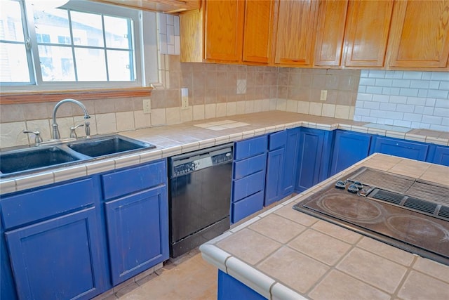 kitchen featuring a sink, light countertops, decorative backsplash, black appliances, and blue cabinets