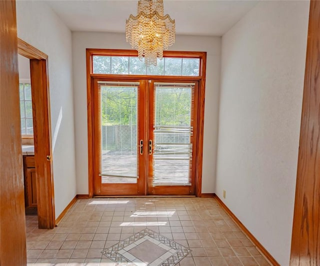 entryway featuring light tile patterned floors, baseboards, a chandelier, and french doors