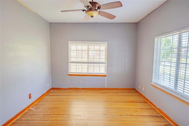 unfurnished room featuring baseboards, ceiling fan, and light wood-type flooring
