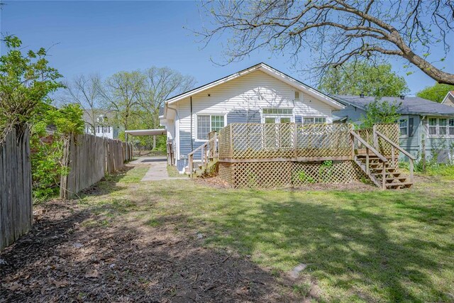 back of house featuring fence, stairs, a yard, and a deck