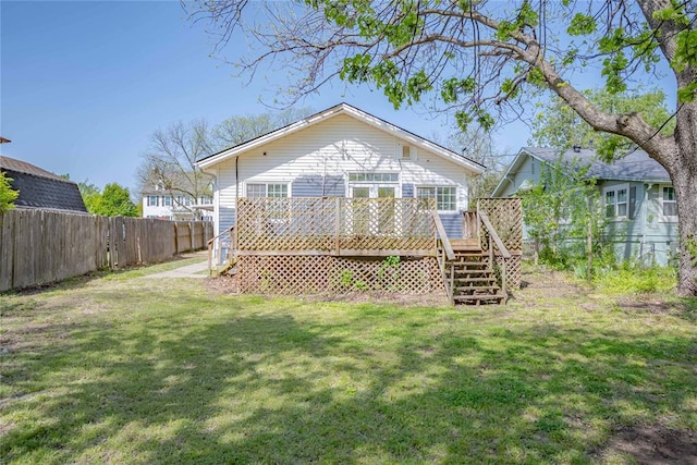 back of house featuring a lawn, stairway, fence, and a deck