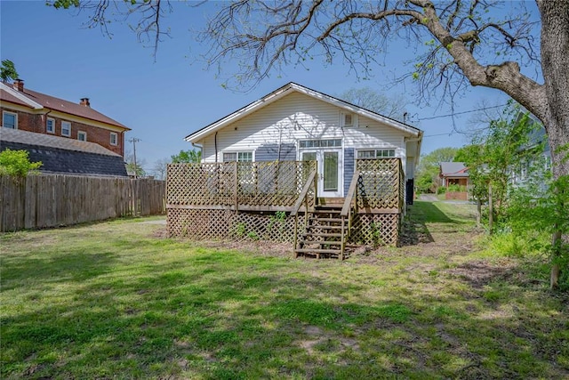 back of property featuring fence, stairs, a yard, and a deck