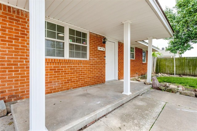 view of patio / terrace featuring fence and covered porch