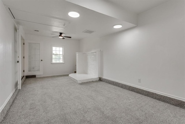 unfurnished room featuring visible vents, baseboards, attic access, ceiling fan, and carpet flooring