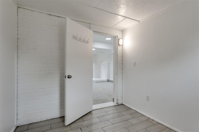 interior space with baseboards and wood finish floors