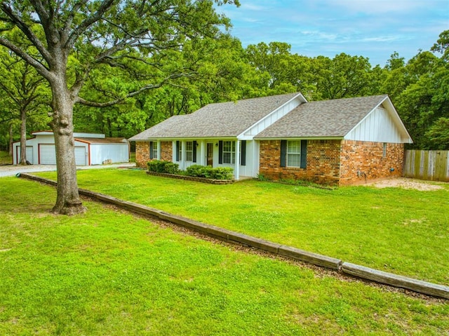 ranch-style house featuring a garage, fence, a front lawn, an outdoor structure, and brick siding