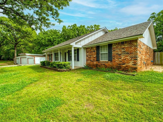 ranch-style house with brick siding, an outbuilding, and a front yard