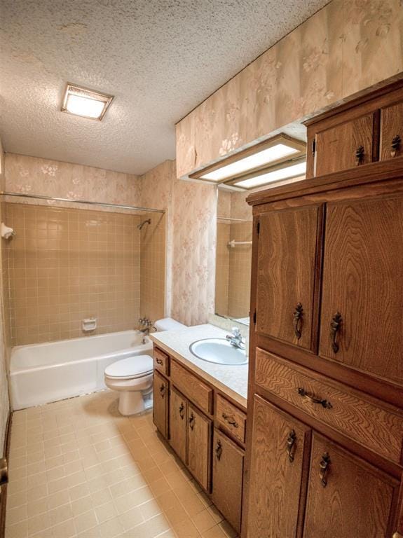 bathroom featuring toilet, bathtub / shower combination, a textured ceiling, tile patterned flooring, and vanity