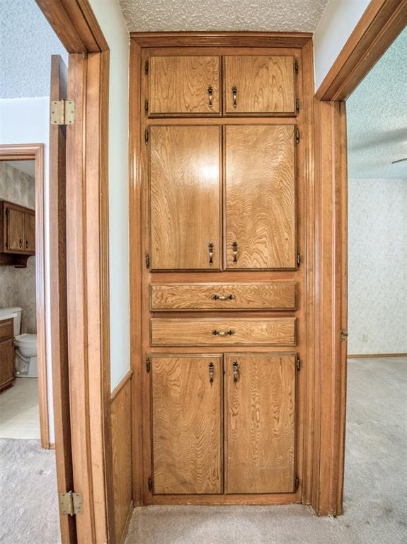 details with carpet, a textured ceiling, and wallpapered walls