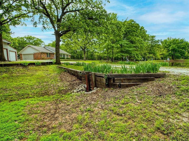 view of yard with a water view and a garage