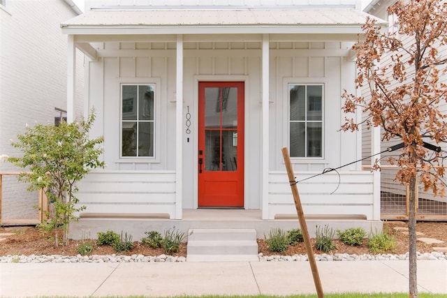 property entrance with board and batten siding and metal roof