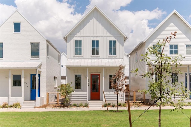 modern farmhouse with entry steps, board and batten siding, a porch, and a front lawn