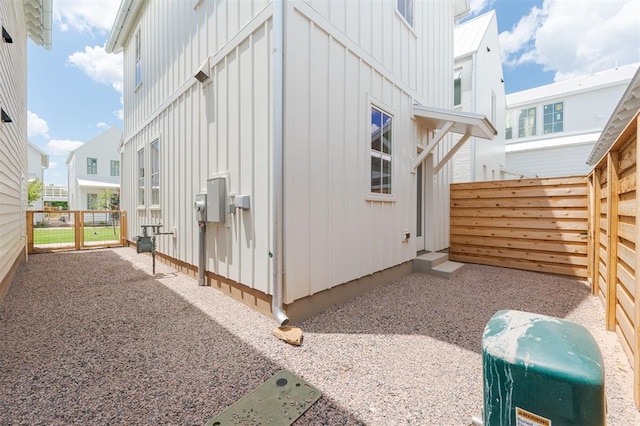 view of property exterior with a fenced backyard and board and batten siding