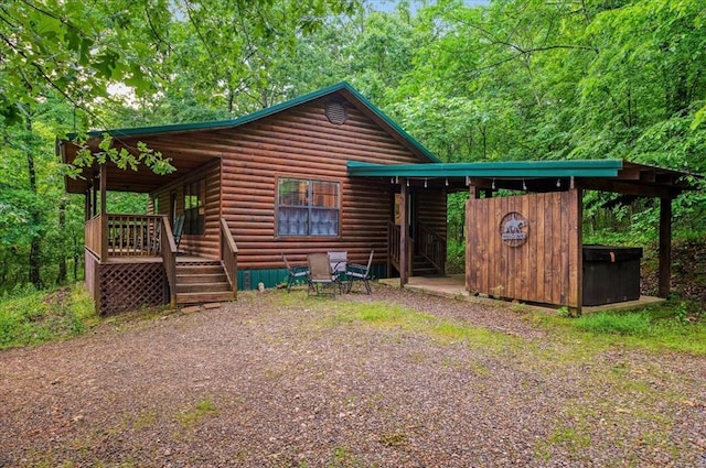 206 Orca Rd, Broken Bow, OK 74728 - rear view of property featuring faux log siding and a deck