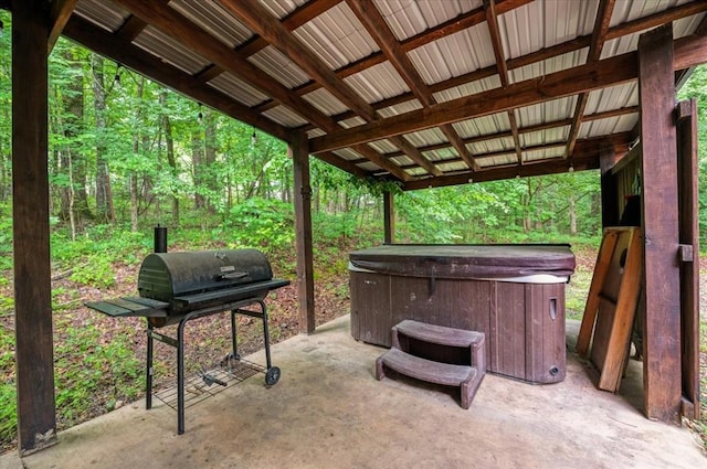 206 Orca Rd, Broken Bow, OK 74728 - view of patio with a hot tub, a grill, and a forest view