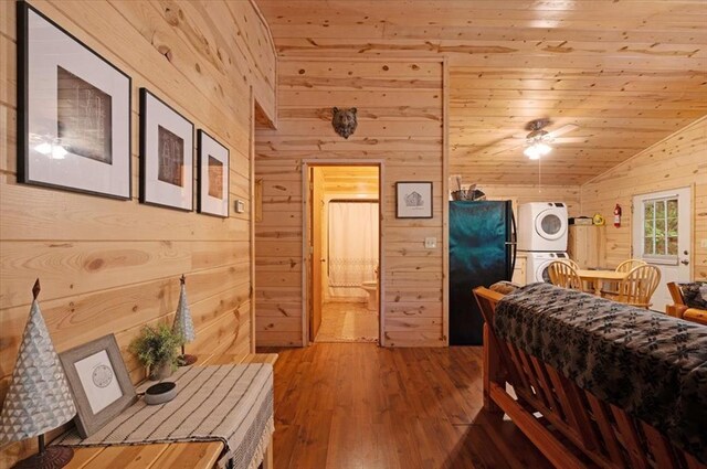206 Orca Rd, Broken Bow, OK 74728 - bedroom with wood walls, stacked washer / dryer, vaulted ceiling, wood-type flooring, and wood ceiling
