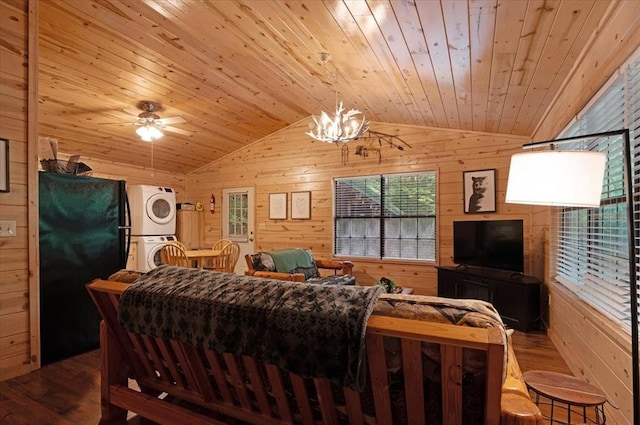 206 Orca Rd, Broken Bow, OK 74728 - living area featuring stacked washer / dryer, wood walls, lofted ceiling, wood finished floors, and healthy amount of natural light