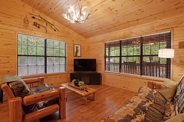 206 Orca Rd, Broken Bow, OK 74728 - living area with vaulted ceiling, wood walls, a chandelier, wood finished floors, and wood ceiling