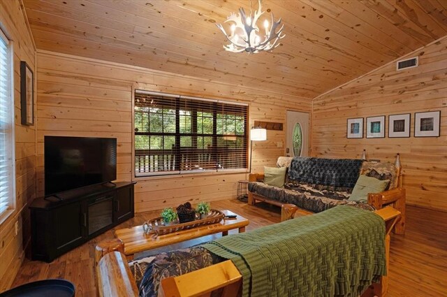 206 Orca Rd, Broken Bow, OK 74728 - living room featuring lofted ceiling, wooden walls, a chandelier, wood finished floors, and wooden ceiling