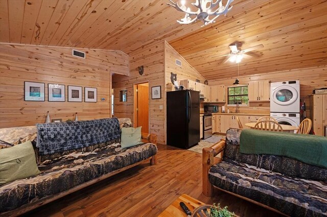 206 Orca Rd, Broken Bow, OK 74728 - living room featuring stacked washing machine and dryer, wooden walls, wood ceiling, a chandelier, and vaulted ceiling