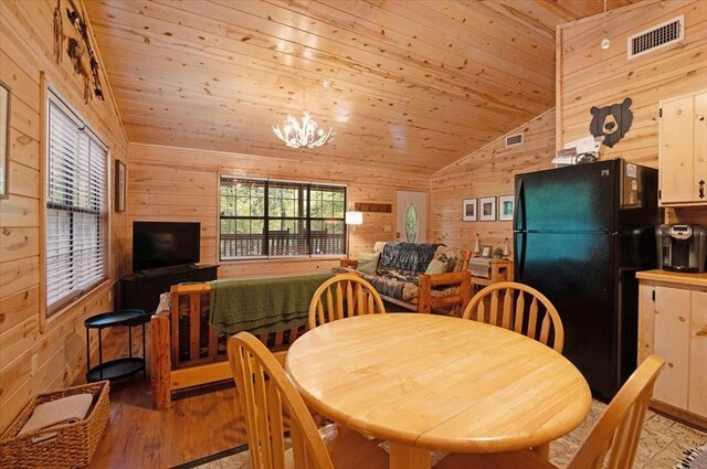 206 Orca Rd, Broken Bow, OK 74728 - dining space with wooden walls, vaulted ceiling, wood ceiling, light wood-style flooring, and a chandelier