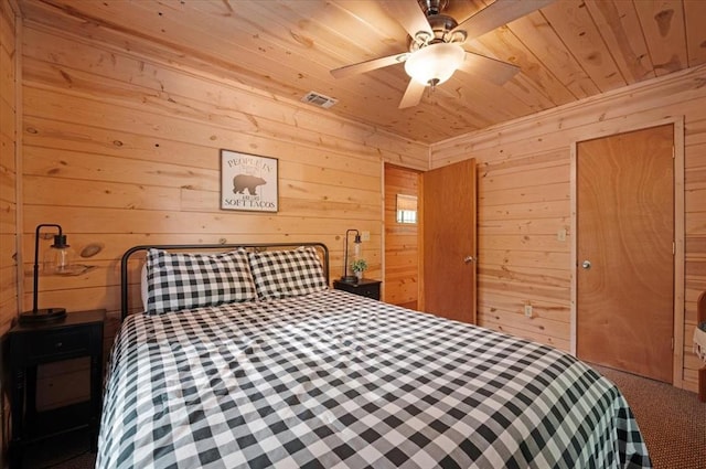 206 Orca Rd, Broken Bow, OK 74728 - bedroom with wooden ceiling, wooden walls, a ceiling fan, and carpet floors