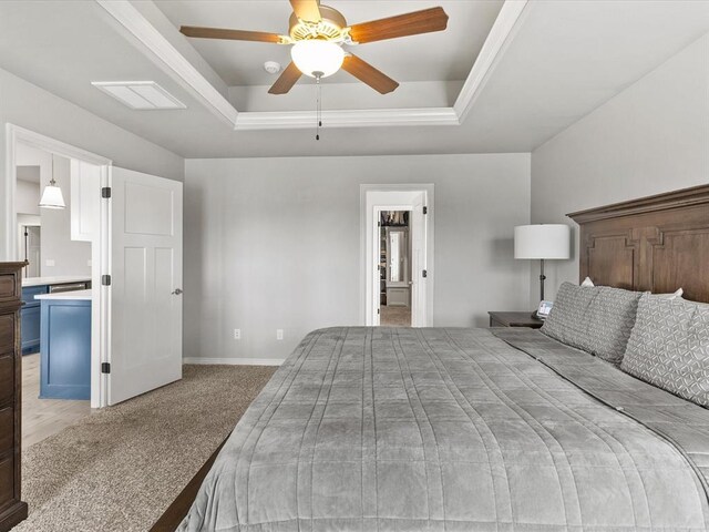 bedroom featuring baseboards, a tray ceiling, visible vents, and light colored carpet