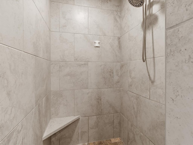 interior details with a tile shower