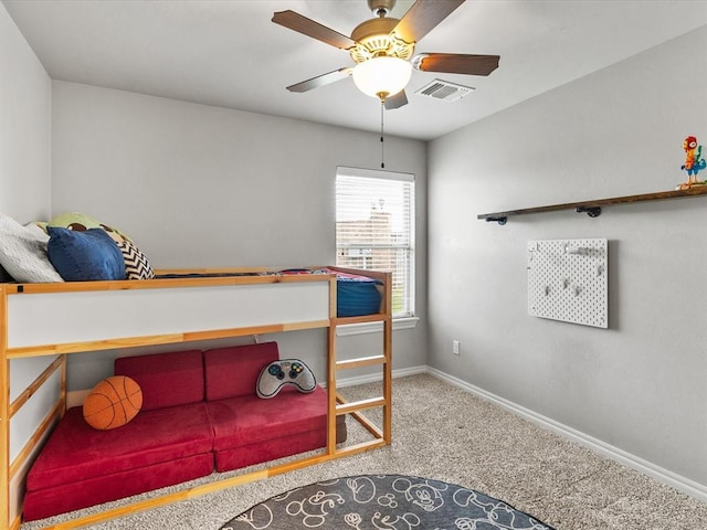 carpeted bedroom with baseboards, a ceiling fan, and visible vents