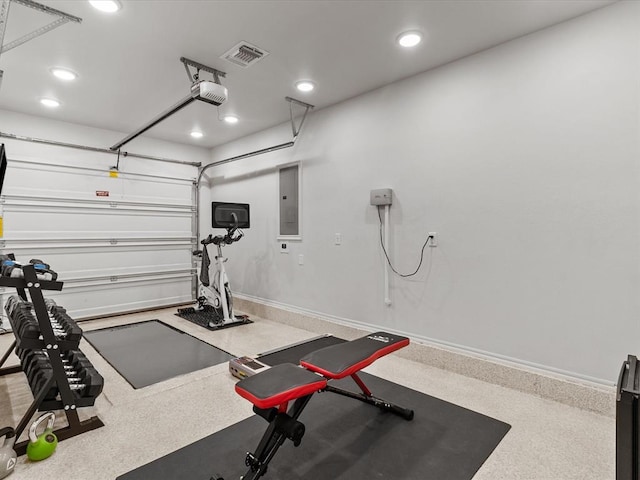 workout room with recessed lighting, visible vents, a garage, and electric panel