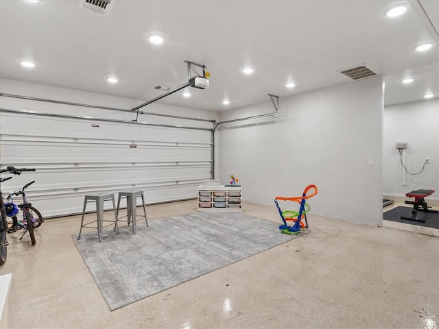 garage with visible vents, baseboards, a garage door opener, and recessed lighting
