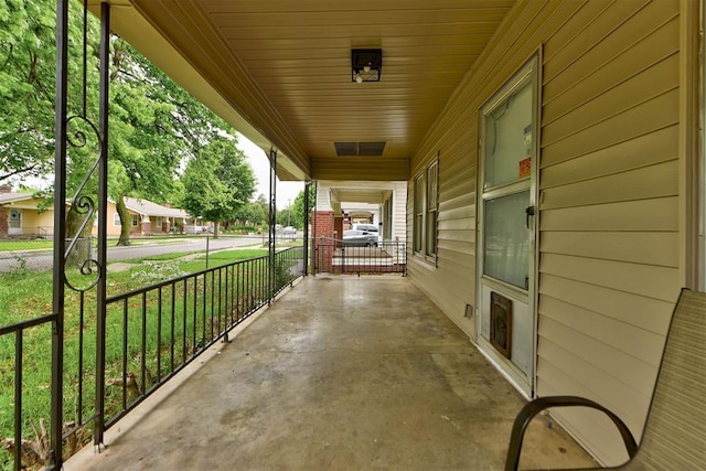 1629 Birch St, Oklahoma City, OK 73108 - view of patio / terrace with a porch and an attached carport