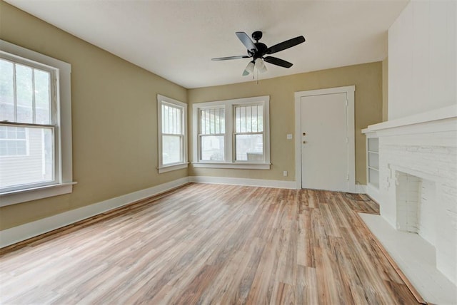 1629 Birch St, Oklahoma City, OK 73108 - unfurnished living room featuring a ceiling fan, a wealth of natural light, baseboards, and light wood-type flooring