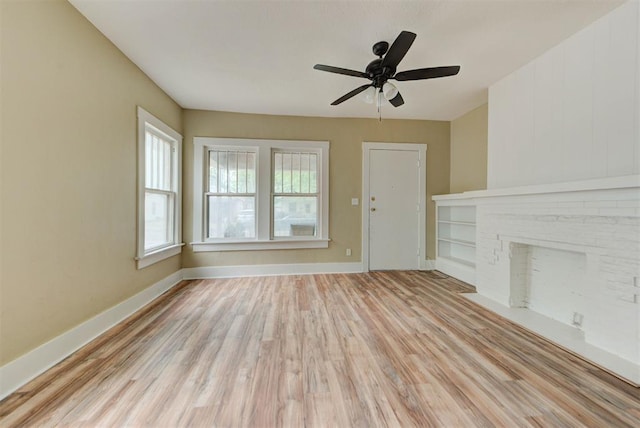 1629 Birch St, Oklahoma City, OK 73108 - unfurnished living room with a ceiling fan, baseboards, a fireplace, and light wood-type flooring