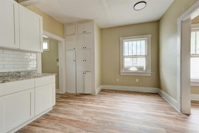 1629 Birch St, Oklahoma City, OK 73108 - unfurnished dining area featuring light wood finished floors and baseboards