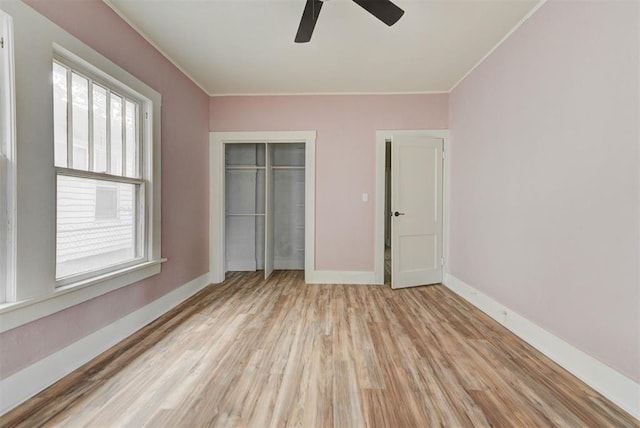 1629 Birch St, Oklahoma City, OK 73108 - unfurnished bedroom with a ceiling fan, a closet, light wood-style flooring, baseboards, and crown molding