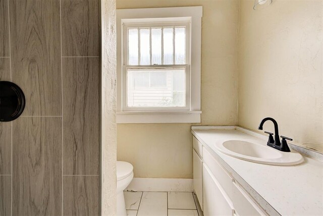 1629 Birch St, Oklahoma City, OK 73108 - full bathroom featuring vanity, toilet, baseboards, and a shower