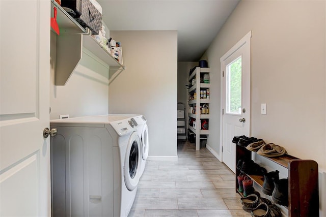washroom with baseboards, laundry area, washing machine and dryer, and light wood-style flooring