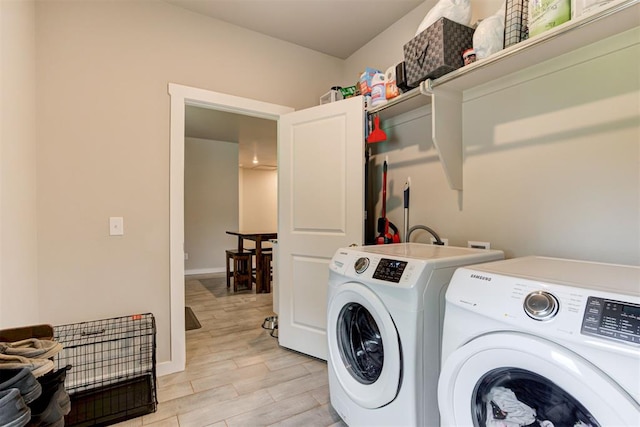 laundry room featuring independent washer and dryer, laundry area, baseboards, and light wood-style floors
