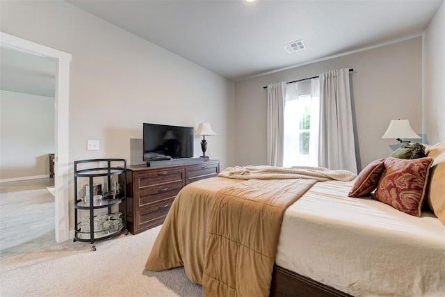 bedroom featuring baseboards, vaulted ceiling, and visible vents