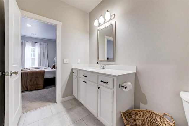 ensuite bathroom with vanity, toilet, tile patterned floors, ensuite bathroom, and visible vents